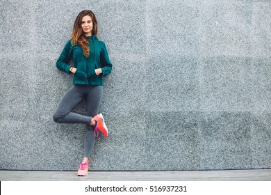 Fitness sport girl in fashion sportswear doing yoga fitness exercise in the street, outdoor sports, urban style