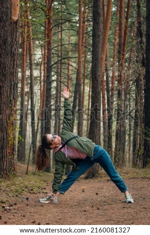 Similar – Woman walking on a fallen tree trunk