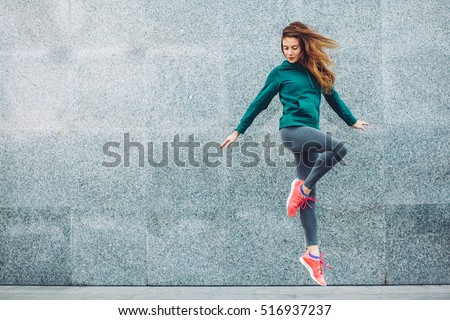 Fitness sport girl in fashion sportswear doing yoga fitness exercise in the street, outdoor sports, urban style