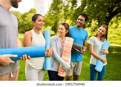 Fitness, Sport And Healthy Lifestyle Concept - Group Of Happy People With Yoga Mats At Park