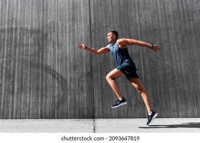 fitness, sport and healthy lifestyle concept - young man running outdoors - Powered by Shutterstock