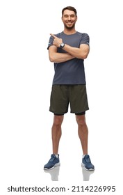 Fitness, Sport And Healthy Lifestyle Concept - Smiling Man In Sports Clothes With Smart Watch Or Tracker Showing Something Invisible Over White Background