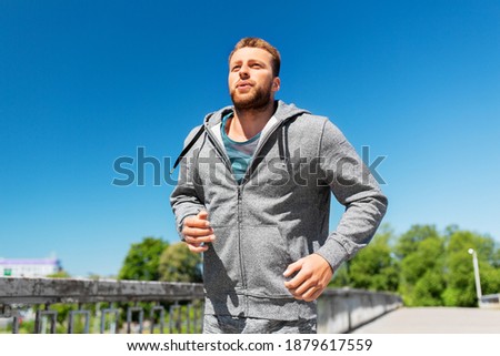 Similar – Image, Stock Photo runner running across the field with his dog