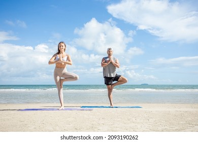 fitness, sport, and lifestyle concept - couple making yoga exercises on beach,  Man and woman doing yoga exercise on the beach. - Powered by Shutterstock