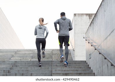fitness, sport, people, exercising and lifestyle concept - couple running upstairs on city stairs - Shutterstock ID 429490462