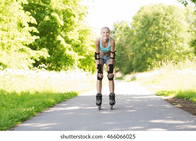 fitness, sport, summer, rollerblading and healthy lifestyle concept - happy young woman in rollerblades and protective gear riding outdoors - Shutterstock ID 466066025