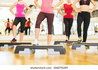 Fitness, Sport, Training, Gym And Lifestyle Concept - Close Up Of Women Legs Steping On Step Platform In Gym