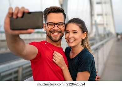 Fitness, Sport, Training, Technology And Lifestyle Concept. Two Smiling People With Smartphones Outdoors