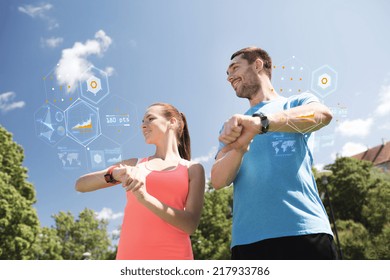 Fitness, Sport, Training, Technology And Lifestyle Concept - Smiling Couple With Heart Rate Watches Outdoors