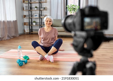 Fitness, Sport And Video Blogging Concept - Happy Senior Woman Or Blogger With Camera Streaming Online Class At Home