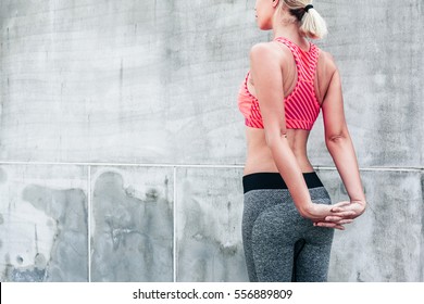 Fitness Sport Woman In Fashion Sportswear Doing Yoga Fitness Exercise In The City Street Over Gray Concrete Background. Outdoor Sports Clothing And Shoes, Urban Style.