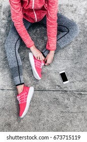 Fitness Sport Woman In Fashion Sportswear Doing Yoga Fitness Exercise In The City Street Over Gray Concrete Background. Outdoor Sports Clothing And Shoes, Urban Style. Tie Sneakers, Top View.