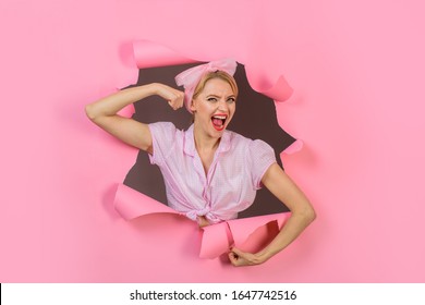 Fitness, sport. Woman showing off her biceps. Girl showing his power. Woman flexing her muscles. Fitness girl. Vintage strong pin up girl looking through hole in paper. Exercising, training concept.