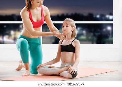 Fitness, Sport, Yoga  - 10 Years Old  Girl Stretching  With Personal Trainer At Fitness Class In Evening