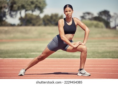 Fitness, sports and black woman stretching on track getting ready to start running, exercise and workout. Wellness, marathon training and female athlete stretch legs for performance on running track - Powered by Shutterstock