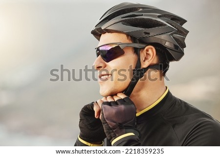 Fitness, sports and cyclist checking his helmet before cycling, training, workout and cardio ride in nature. Health, biking and athletic man getting ready for cycle, happy, smile and relaxed training