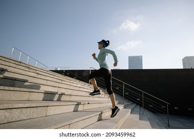 Fitness sports woman running up stairs in city - Shutterstock ID 2093459962