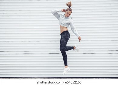 Fitness Sporty Girl In Fashion Sportswear Dancing Hip Hop In The Street, Outdoor Sports, Urban Style. Teen Model In Swag Clothes Posing Outside.