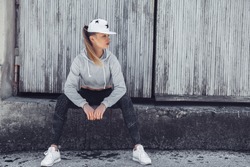 Fitness sporty girl wearing fashion sportswear over street wall