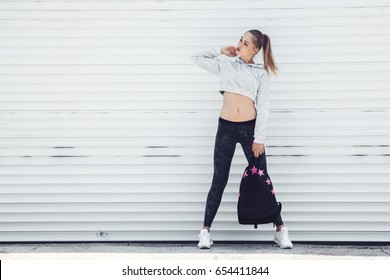 Fitness Sporty Girl Wearing Fashion Sportswear Over Street Wall, Outdoor Sports, Urban Style. Teen Model In Swag Clothes Posing Outside.