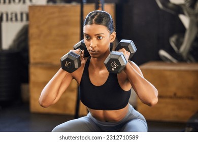 Fitness, squat or woman with dumbbells training, exercise or workout for powerful arms or muscles in gym. Dumbbell squats, bodybuilder or Indian girl athlete lifting weights or exercising biceps