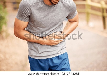 Fitness, stomach ache and man outdoor after running, workout or exercise. Sports, abdominal pain and male athlete in nature with injury, emergency or problem, sick or hernia after training mockup.