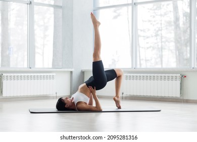 Fitness, Stretching Workout, Attractive Mature Woman In Black And White Sportswear Working Out In Sports Club, Keeping Fit, Doing Backbend Pose, One-legged Shoulder Bridge Exercise In Class, 