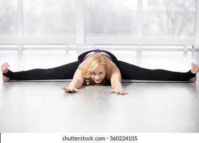 Fitness, Stretching Workout, Attractive Mature Happy Woman Working Out In Sports Club, Keeping Fit, Doing Wide-Angle Seated Forward Bend Pose, Upavishtha Konasana Posture In Class