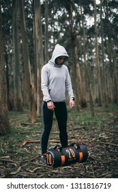 Fitness Strong Woman Getting Prepared For Lifting Heavy Bag During Outdoors Strength Workout.