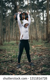 Fitness Strong Woman Working Out Outoors Lifting Heavy Bag For Strength Training.