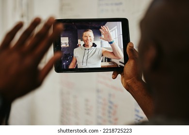 Fitness, tablet or man wave on video call for networking, communication or personal trainer consulting customer. Health, gym or happy coach for waving, tech or motivation for workout exercise goal - Powered by Shutterstock