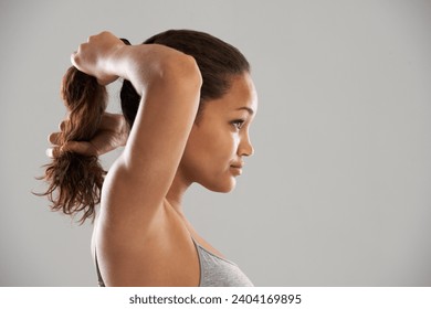 Fitness, tie hair or profile of model isolated on grey background for wellness or sports. Woman, ponytail or person with natural hairstyle ready to start exercise, training or workout in studio - Powered by Shutterstock