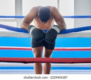 Fitness, tired and sad boxer after a loss thinking about his defeat in a difficult battle in a boxing ring at a gym studio. Fatigue, loser and frustrated fighter feeling bad, depression and upset - Powered by Shutterstock