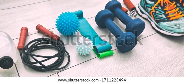The fitness tools\
and  a equipment on the wooden floor. Concept of home physical\
training and staying at\
home