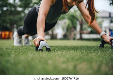 Fitness training outdoor, Healthy lifestyle concept Closeup - Sport woman doing push ups in the park.