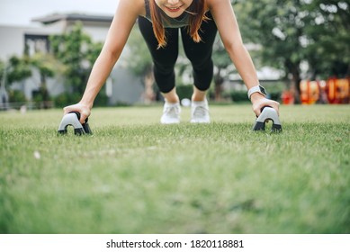Fitness training outdoor, Healthy lifestyle concept Closeup - Sport woman doing push ups in the park.