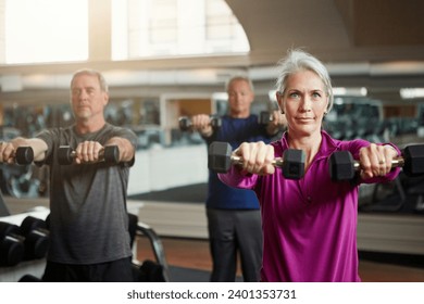 Fitness, training and senior people with dumbbells at gym for club exercise, wellness or cardio, health or strength. Class, workout or elderly friends at sports studio for bodybuilding weightlifting - Powered by Shutterstock