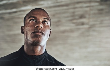 Fitness Transforms The Body Along With The Mind. Shot Of A Sporty Young Man Exercising Outdoors.