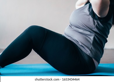 Fitness, Weight Loss, Home Workout. Overweight Woman Doing Sit-ups On Mat Indoors