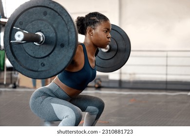 Fitness, weightlifting and barbell with black woman in gym for workout, strong and muscle. Health, challenge and exercise with female bodybuilder and weights for focus, performance and commitment