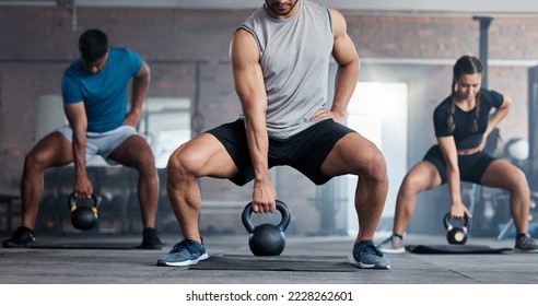 Fitness, weightlifting and kettlebell class for arm workout, exercise or training together at the gym. Active people in sports exercising with kettle weights for healthy cardio endurance or wellness - Powered by Shutterstock