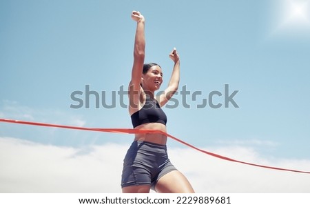 Fitness, winner and sports woman running a race and winning first place in summer in track competition. Runner, goals and happy girl athlete with hands up smile in celebration of a marathon success