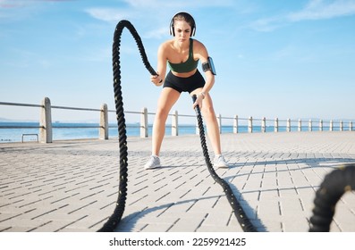 Fitness, woman and battle rope at the beach for intense arm workout, training or endurance exercise. Active female with ropes in power workout, exercising or focus for muscle bodybuilding outdoors - Shutterstock ID 2259921425