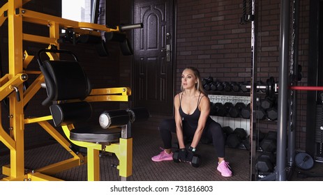 Fitness Woman Doing Dead Lift With Dumbbell In The Gym