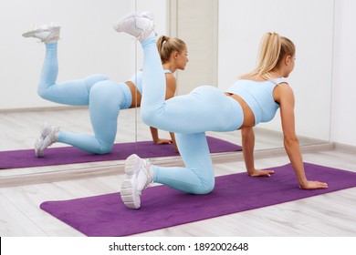 Fitness Woman Doing Donkey Kick Exercise For Glutes. Athletic Girl Working Out
