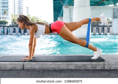 Fitness Woman Doing Exercise For Glutes With Resistance Band Outdoors. Athletic Girl Workout