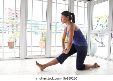 Fitness woman doing her hamstring stretch indoor