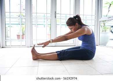 Fitness Woman Doing Her Hamstring Stretch Indoor