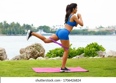 Fitness Woman Doing Kickback Exercise For Glute With Resistance Band, Outdoors. Athletic Girl Workout