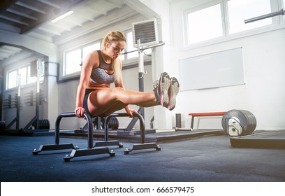 Fitness woman doing L Sit position on parallel bars, calisthenic workout - Powered by Shutterstock